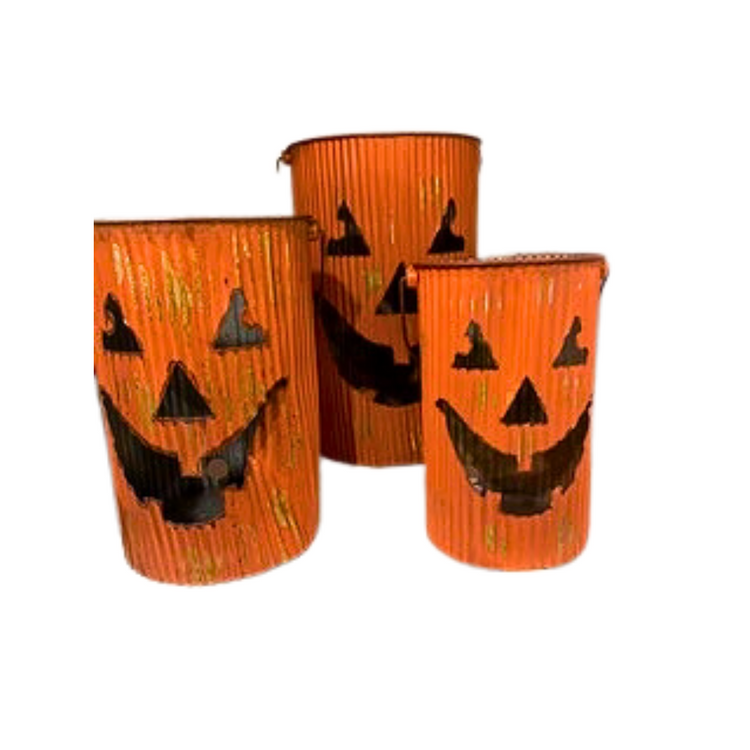 Set of three orange corrugated metal pumpkin lantern buckets with cutout jack-o'-lantern faces.