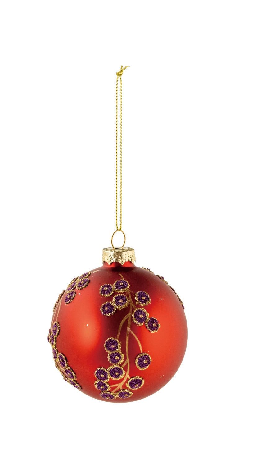 Red glass ball ornament with gold botanical branches and purple beaded berry accents.