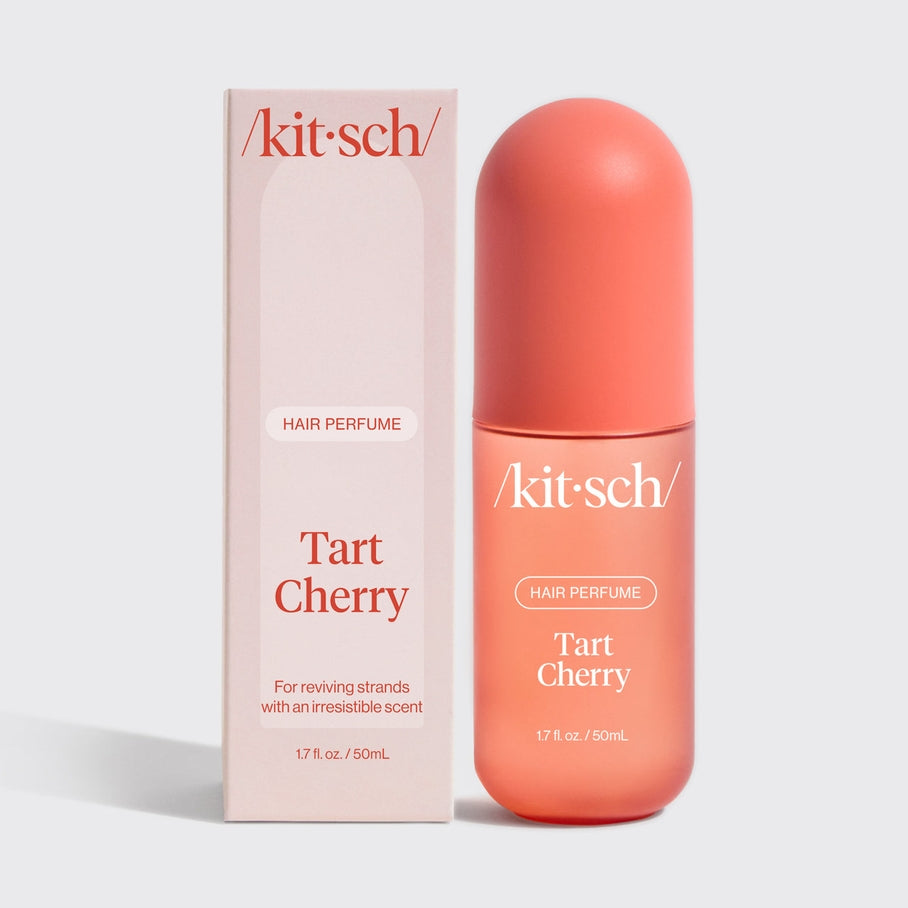 Tart Cherry Hair Perfume bottle with a clear glass body showing pink liquid.