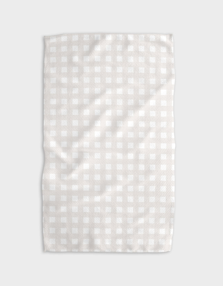 Everyday Kitchen Tea Towel with a light beige and white gingham pattern and waffle weave texture.