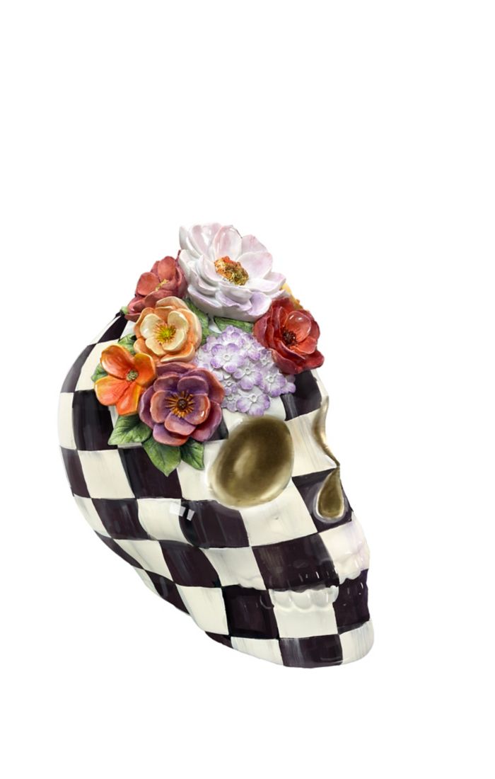 Black and white checkered resin skull with a colorful floral crown and gold accents.