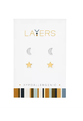 Silver crescent moon and gold star stud earring duo set on a white Layers brand card.