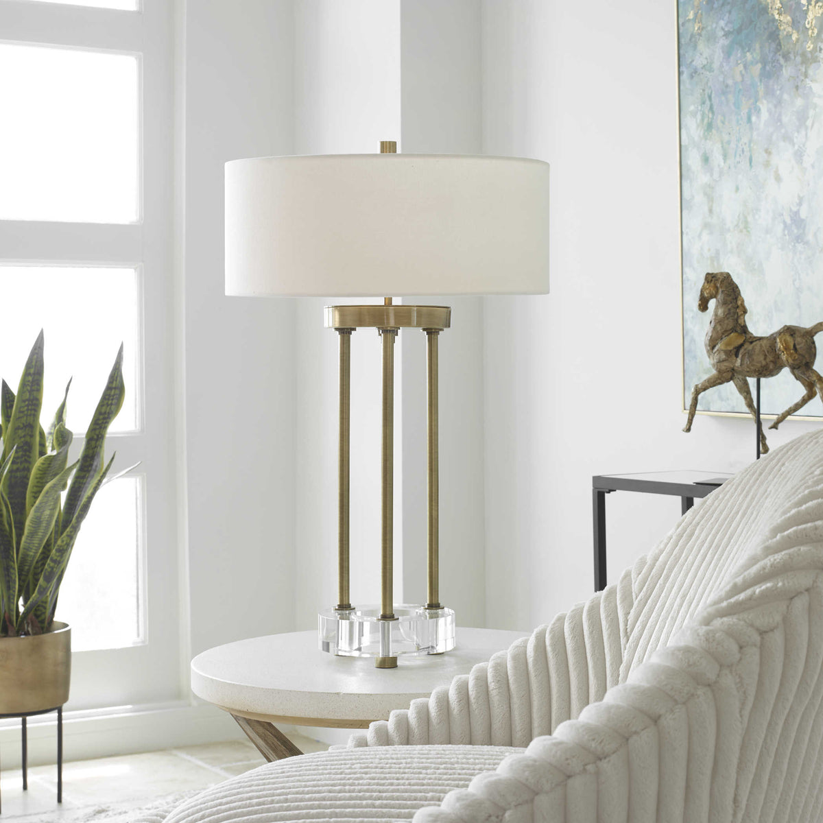 Pantheon table lamp with a cylindrical shade in neutral tones.