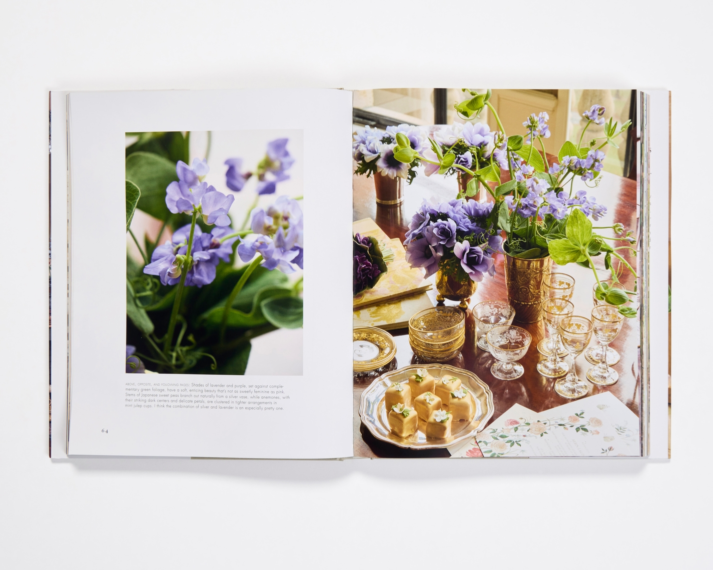 Open pages of Aerin Lauder Living with Flowers book showing purple sweet peas and a table setting.