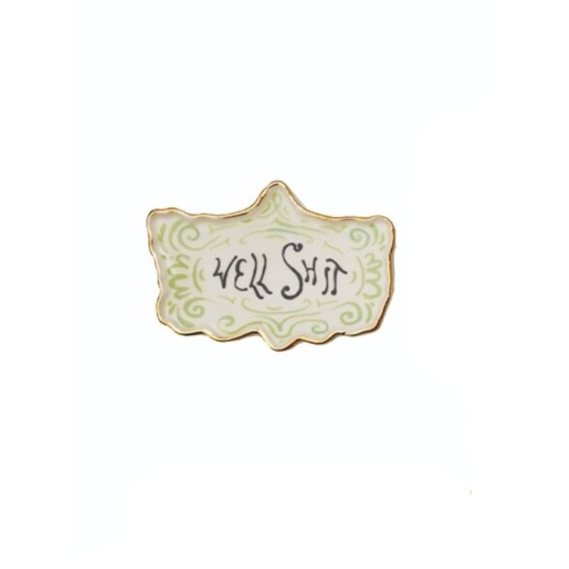Decorative stoneware magnet with a gold electroplated rim and the words "WELL SHIT" in black script.