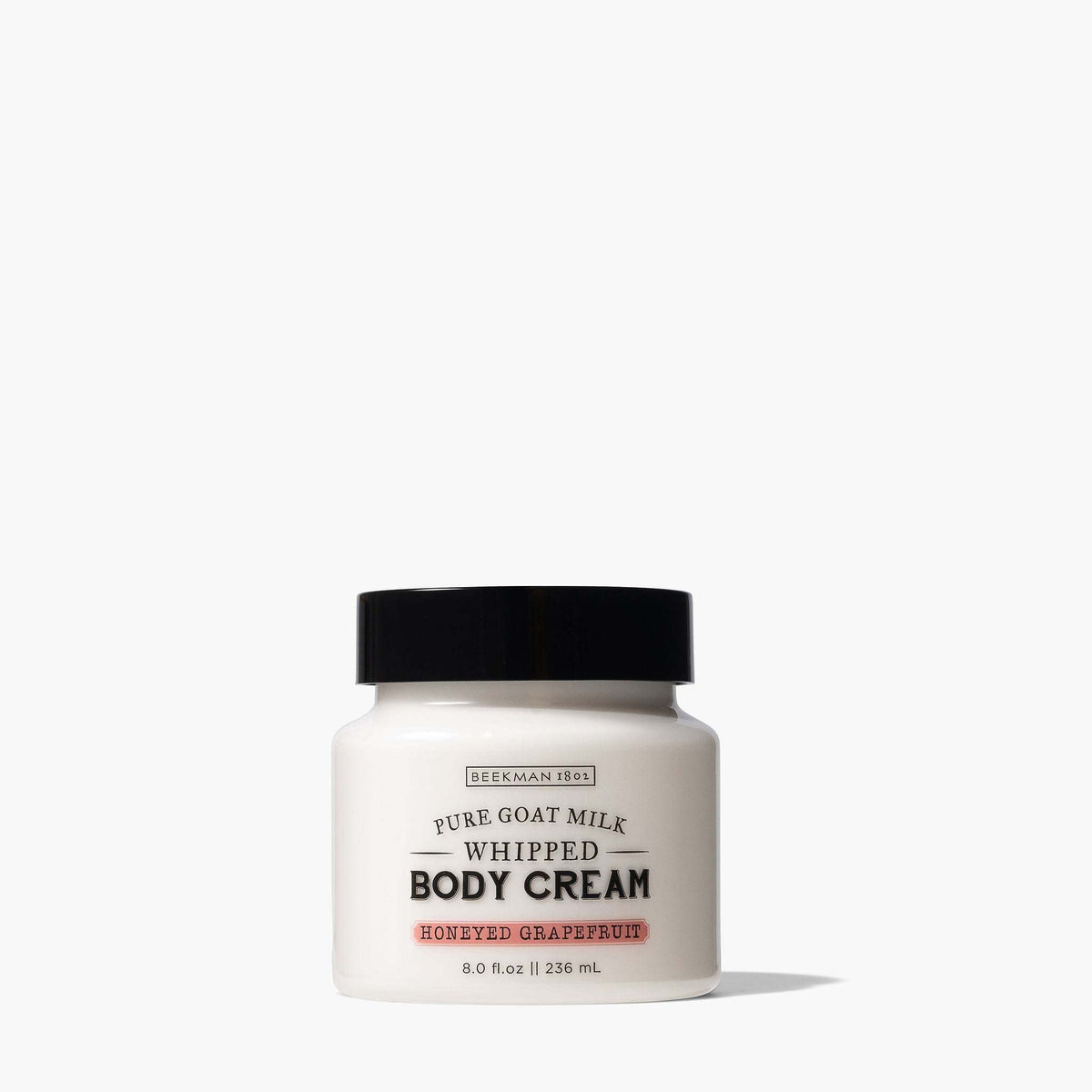 Beekman 1802 Honeyed Grapefruit Whipped Body Cream in an 8 oz white jar with a black lid.