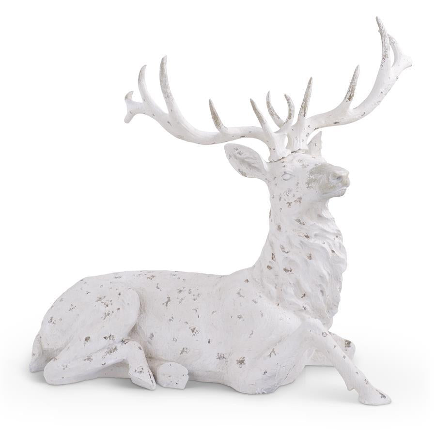 Whitewashed polyresin deer figurine lying down with a naturalistic silhouette.