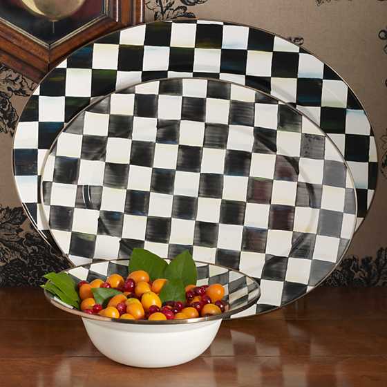 Hand-painted black and white checkered enamel oval platter with a bronzed stainless steel rim.