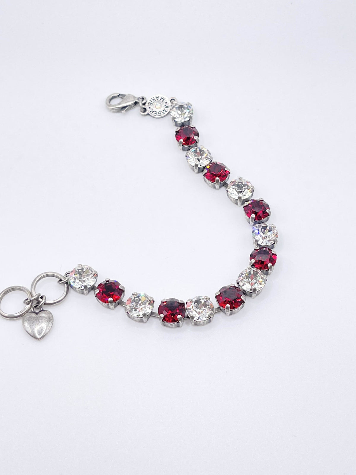 Classic Rome bracelet featuring deep red stones with black accents on a clear band.