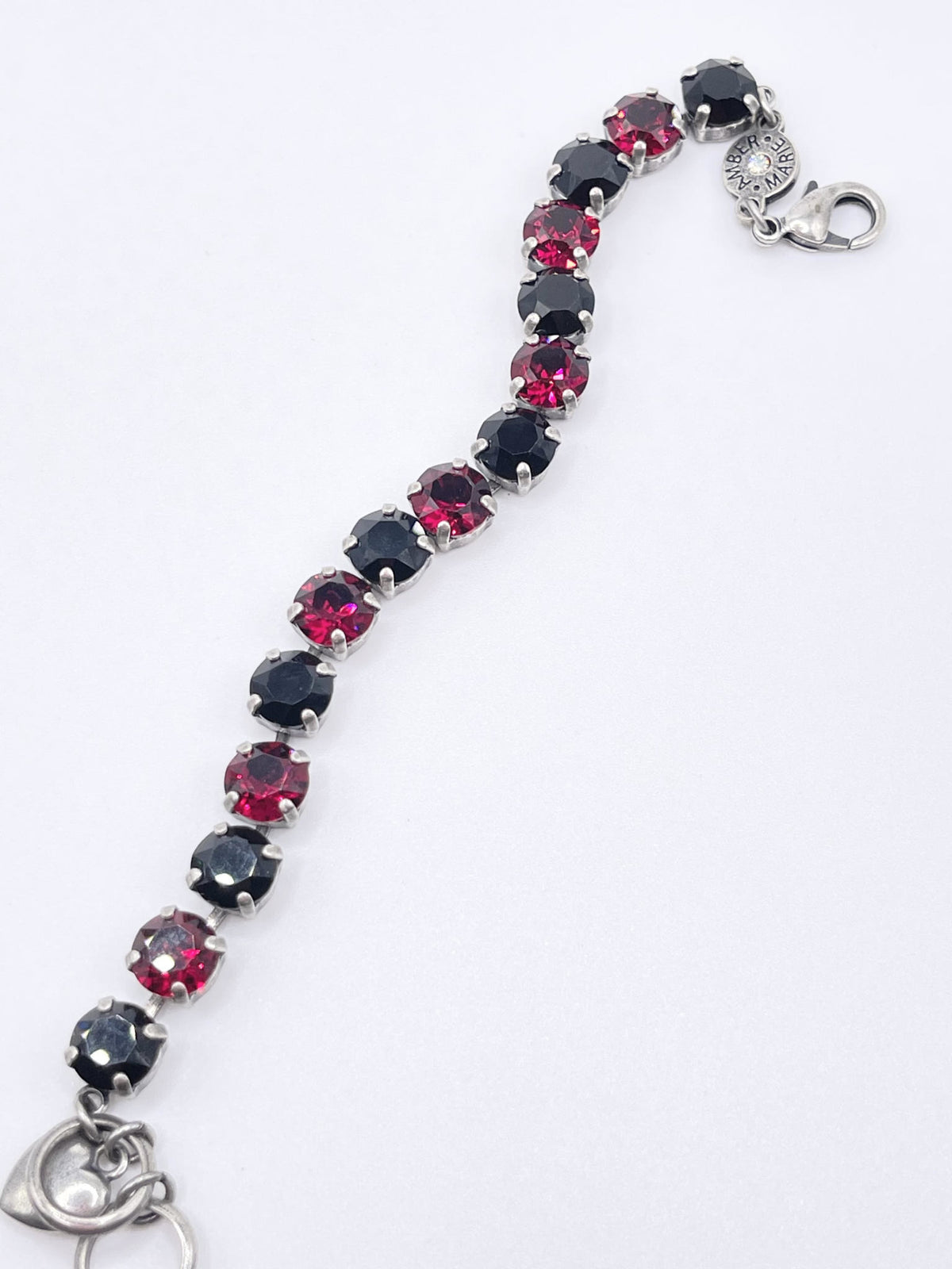 Classic Rome bracelet featuring deep red stones with black accents in a sleek metallic band.