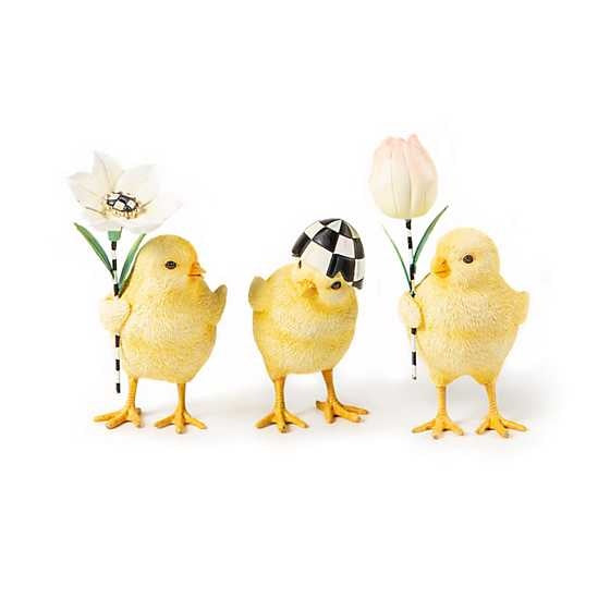 Set of three hand-painted resin garden chicks in pastel colors holding flowers; one wears a cracked egg hat.