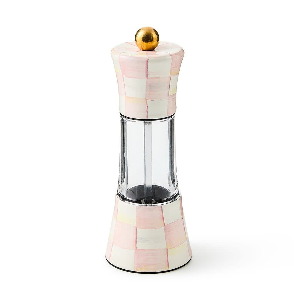 Tall cylindrical steel grinder with hand-painted mocha check pattern on a ceramic base.