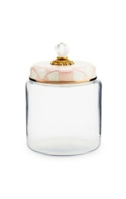 Rosy check glass kitchen canister with bronzed stainless steel lid rimmed in faux cinnabar and brass accents.