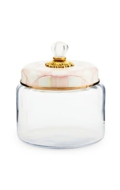 Rosy check glass kitchen canister with bronzed stainless steel lid rimmed in faux cinnabar and brass accents.