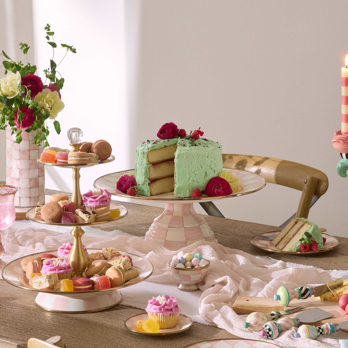 Large pedestal platter with hand-painted rosy check floral pattern on steel base and bronzed stainless rim.