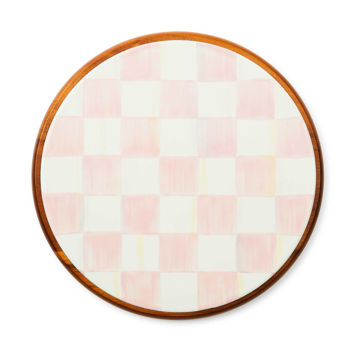 Large round trivet with acacia wood base featuring hand-painted pink check pattern on glazed steel.