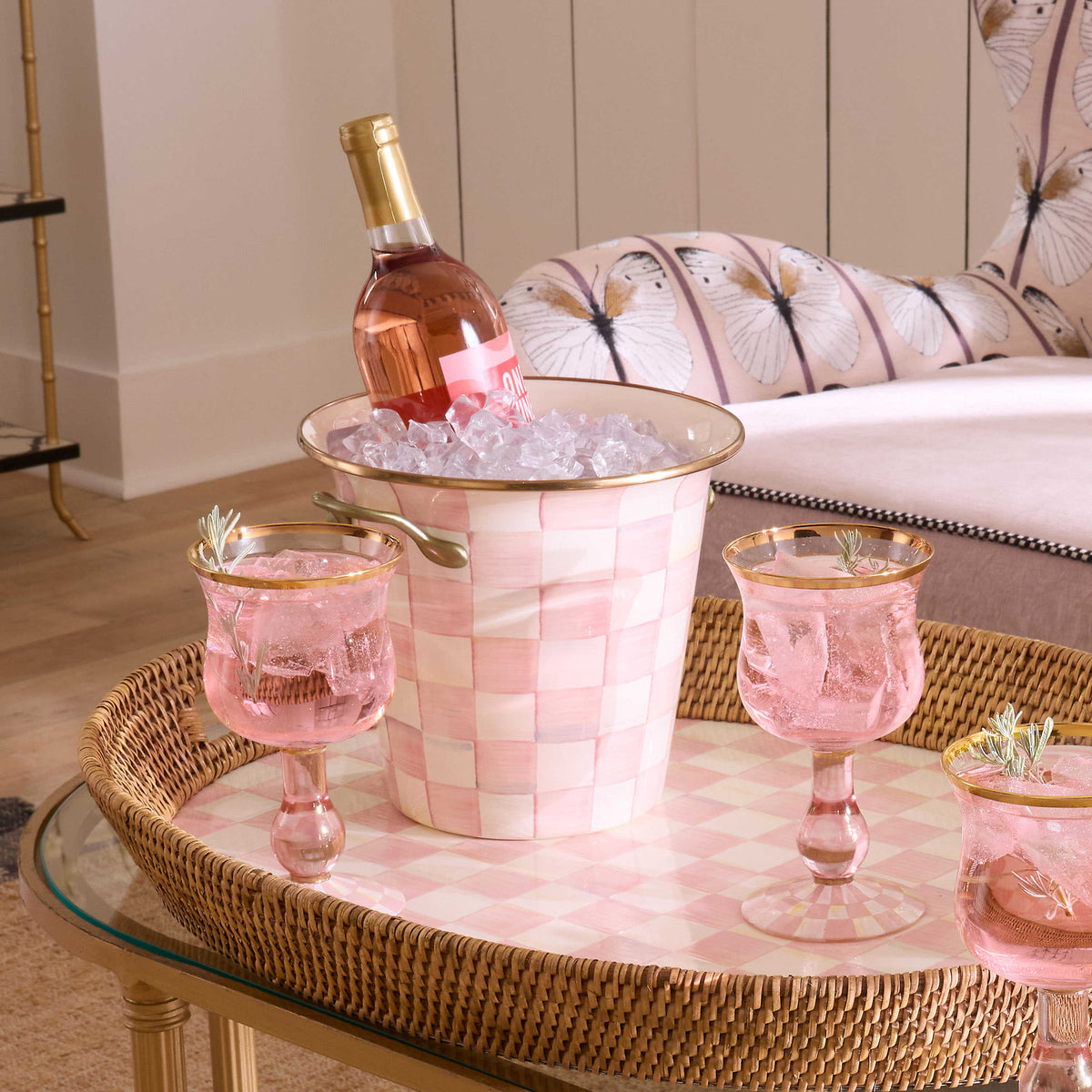 Hand-glazed steel wine cooler with rosy check floral pattern on bronzed stainless rim and antiqued brass handles.