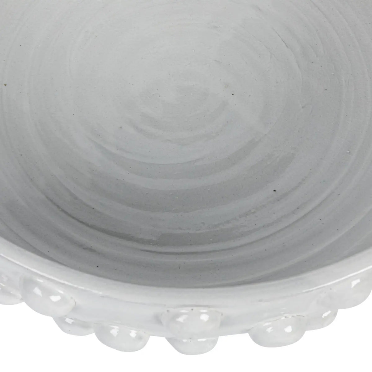 Round terracotta bowl with crackle glaze finish and raised dot texture pattern.