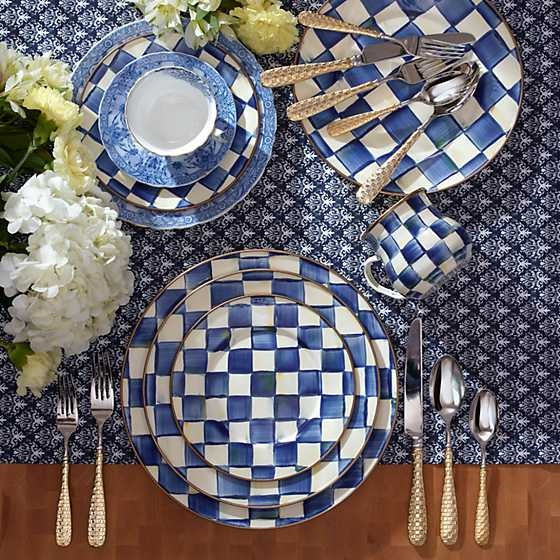 Royal Check enamel dinner plate with hand-painted blue checks on steel rimmed in bronzed stainless steel.