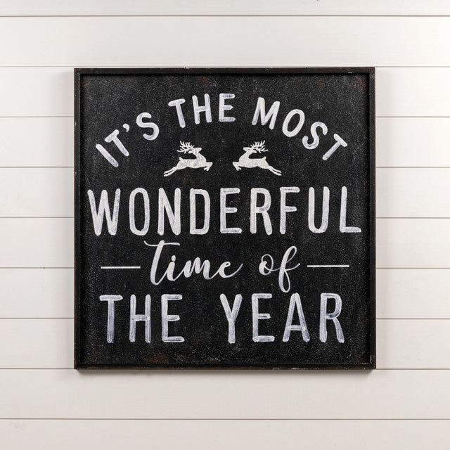 Metal wall sign with wood frame displaying black text on white background reading 'Most Wonderful Time' in a decorative font.