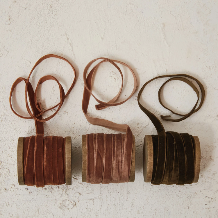 Three wooden spools of 1/4 inch velvet ribbon in rust, dusty rose, and olive green colors.