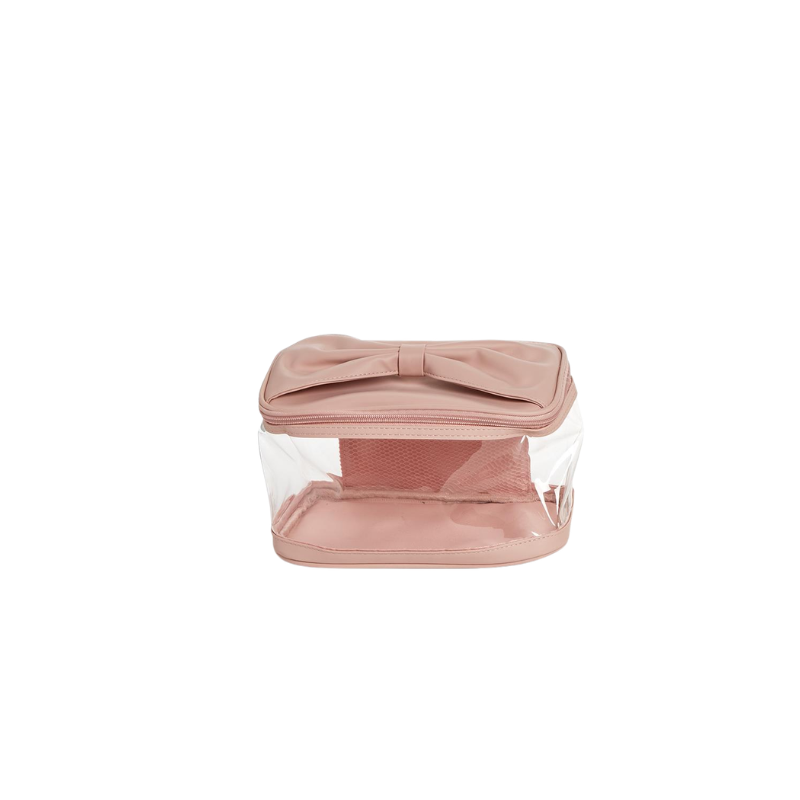 Pink see-through cosmetic case with a large bow on the lid and a zip-around closure.