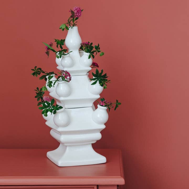 White ceramic tulip vase with a rounded body and narrow neck.