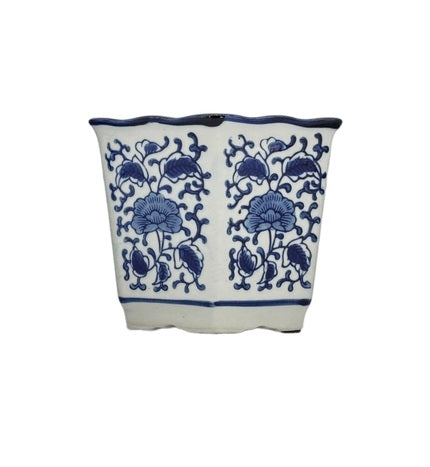 Blue and white hexagonal ceramic pot with ruffled lip edge featuring floral pattern
