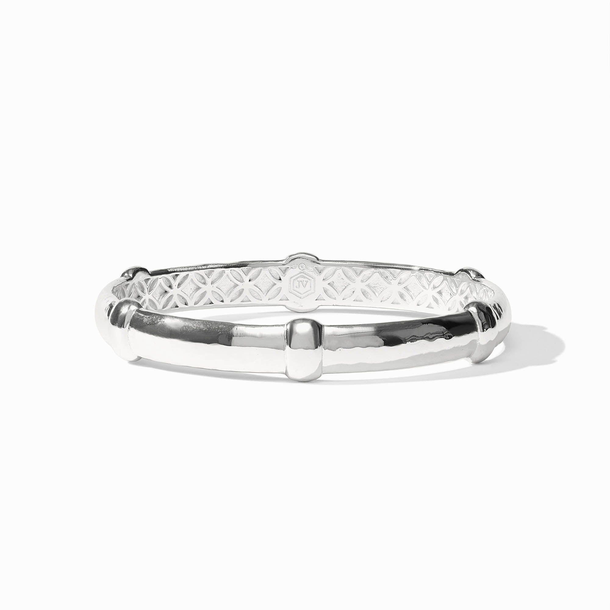 Polished silver Sahara Bangle with a segmented design and intricate interior lattice pattern.