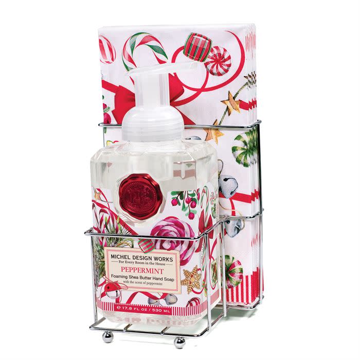 Foaming hand soap dispenser with matching napkin holder set in neutral tones.