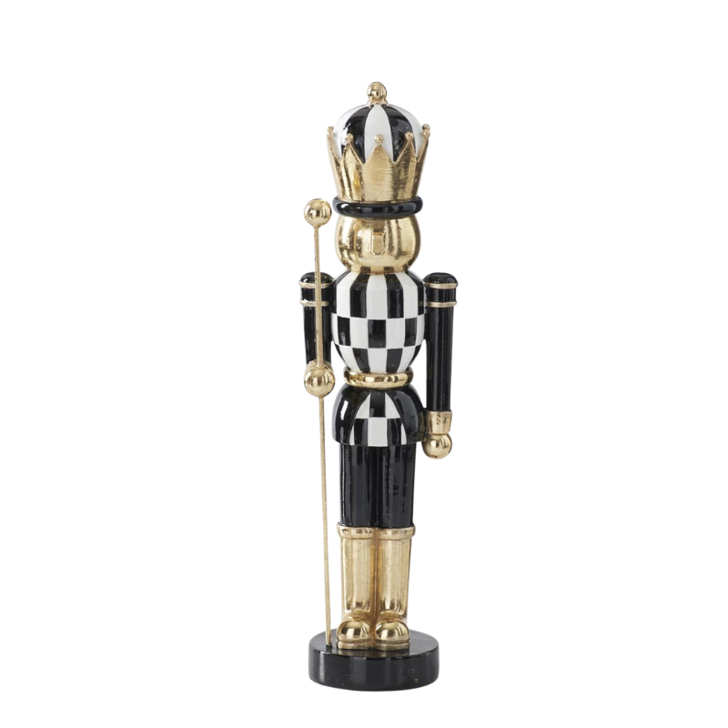 Black, white, and gold resin nutcracker with a checkered torso, gold crown, and staff.