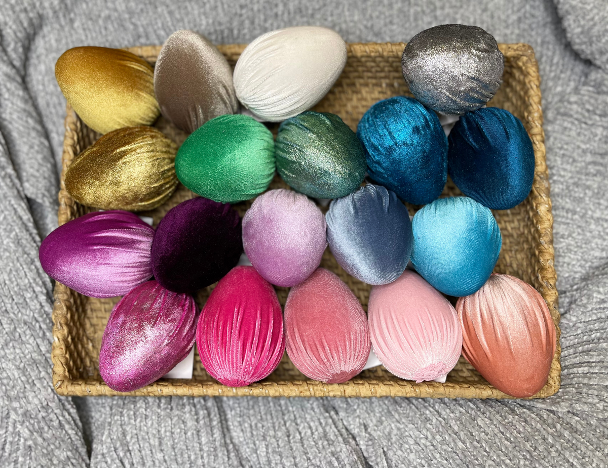 Four-inch tall handmade velvet egg in deep burgundy with a smooth matte finish.