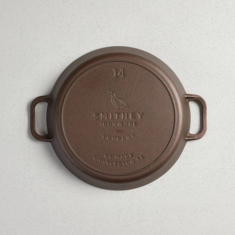 Bottom view of a No. 14 Dual Handle Skillet showing the Smithey Ironware logo and 14 inch marking.