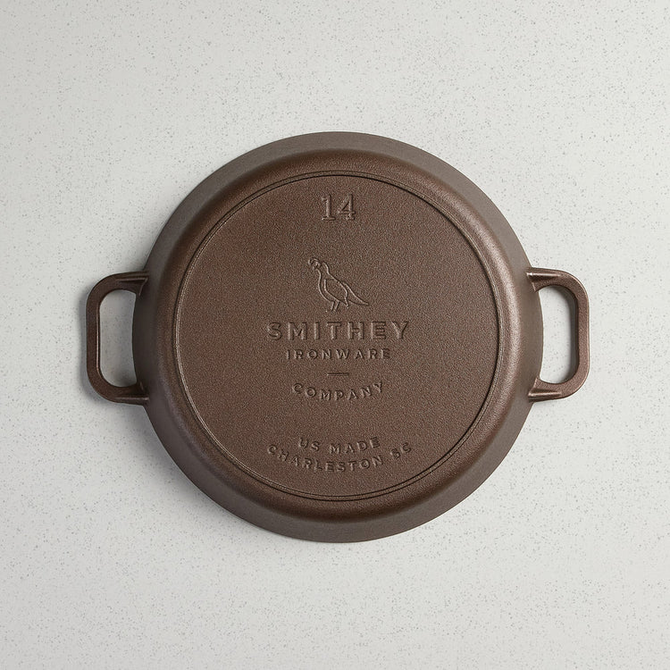 Bottom view of a No. 14 Dual Handle Skillet showing the Smithey Ironware logo and 14 inch marking.