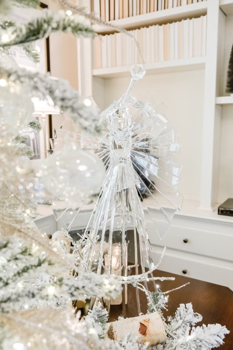 Large clear acrylic angel statue with detachable wings standing on a base.