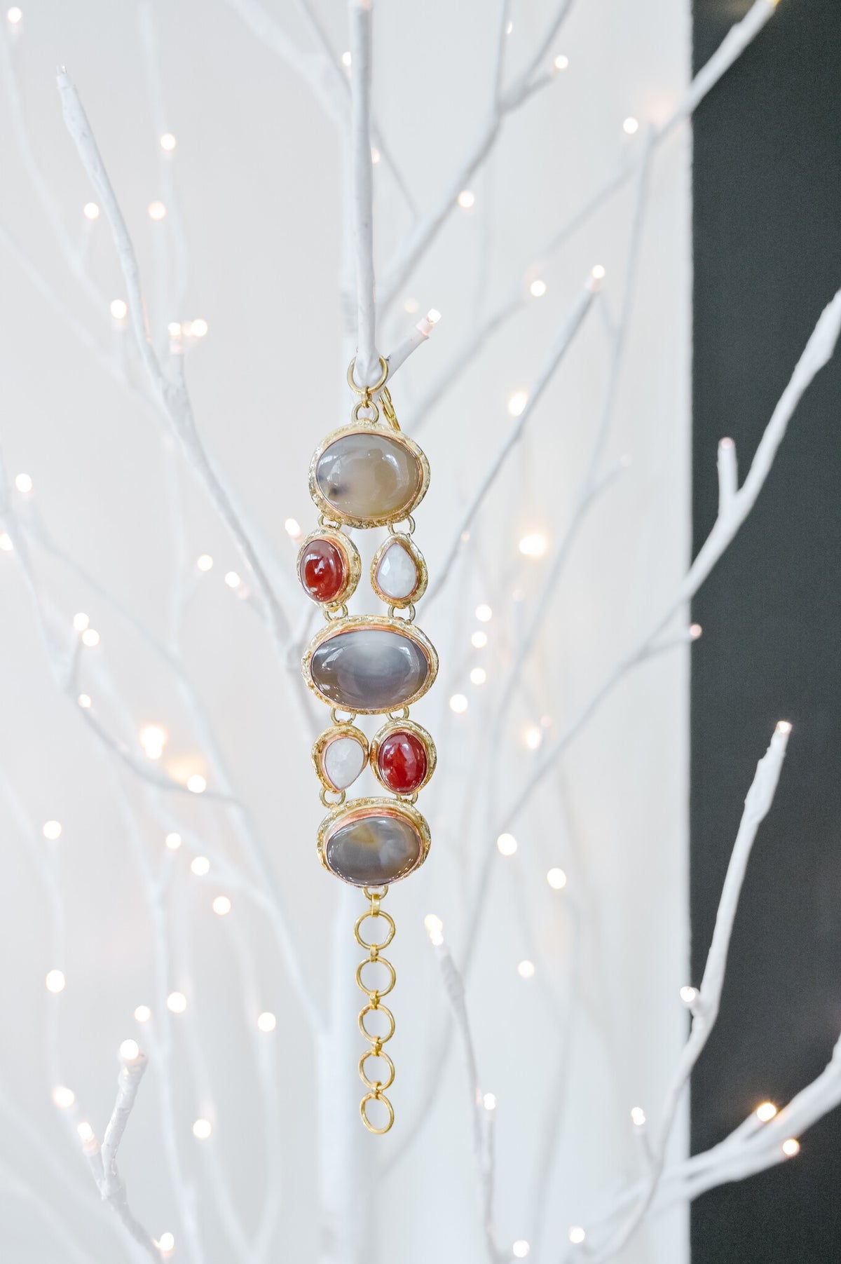 Silver link bracelet featuring seven natural stones including agate, moonstone, and carnelian.
