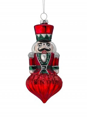 6-inch glass nutcracker finial ornament with red, green, and silver glitter accents.
