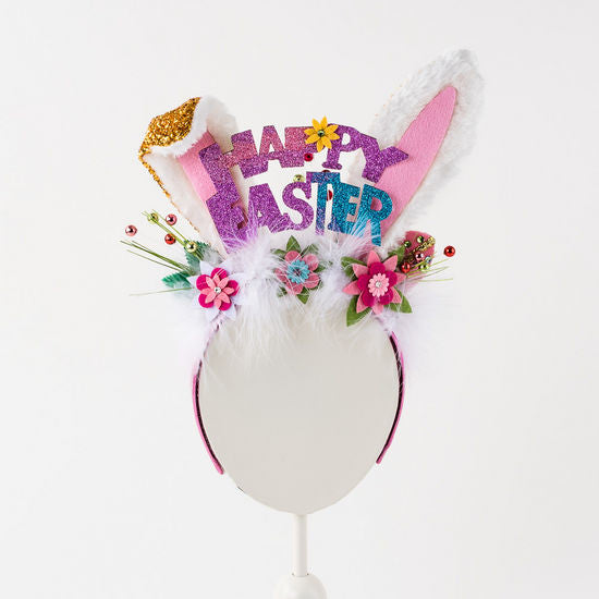 White headband with pink bunny ears featuring a subtle polka dot pattern