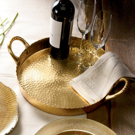 Square hammered brass tray with a gilded handle featuring intricate artisanal detailing.