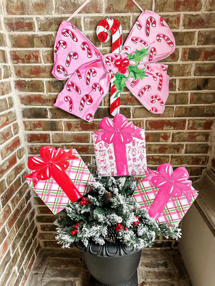 Beck's Vintage Candy Cane Bow PVC door hanger in red with white stripes and a silver bow.