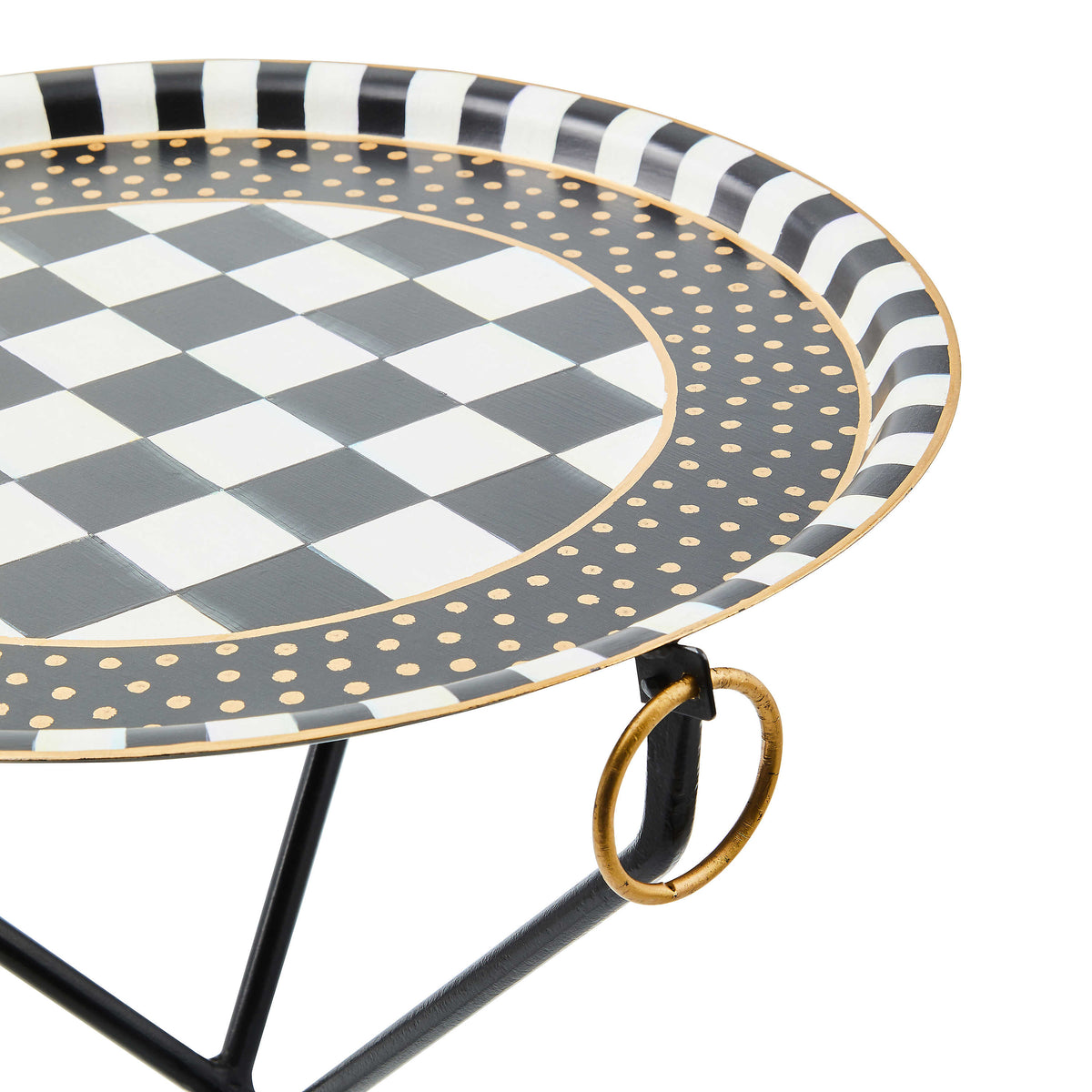 Close-up of a Tilt Top Black Tripod Table featuring hand-painted black and white checks and dots.