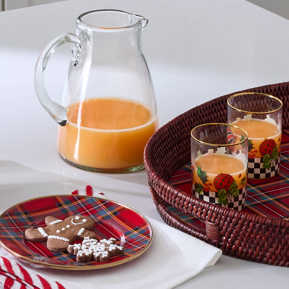 Deck the Halls Tumbler with holiday patterns and gold rim, shown with a pitcher and cookies.