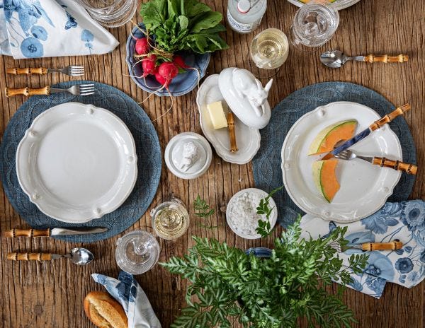 Overhead view of Berry & Thread Whitewash Flared Cocktail Plates on a rustic wooden table setting.