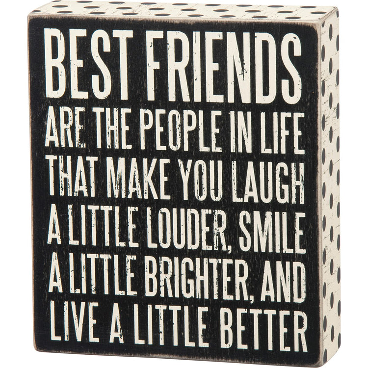 Black wooden box sign with white text reading 'BEST FRIENDS ARE THE PEOPLE IN LIFE THAT MAKE YOU LAUGH A LITTLE LOUDER, SMILE A LITTLE BRIGHTER, AND LIVE A LITTLE BETTER'.