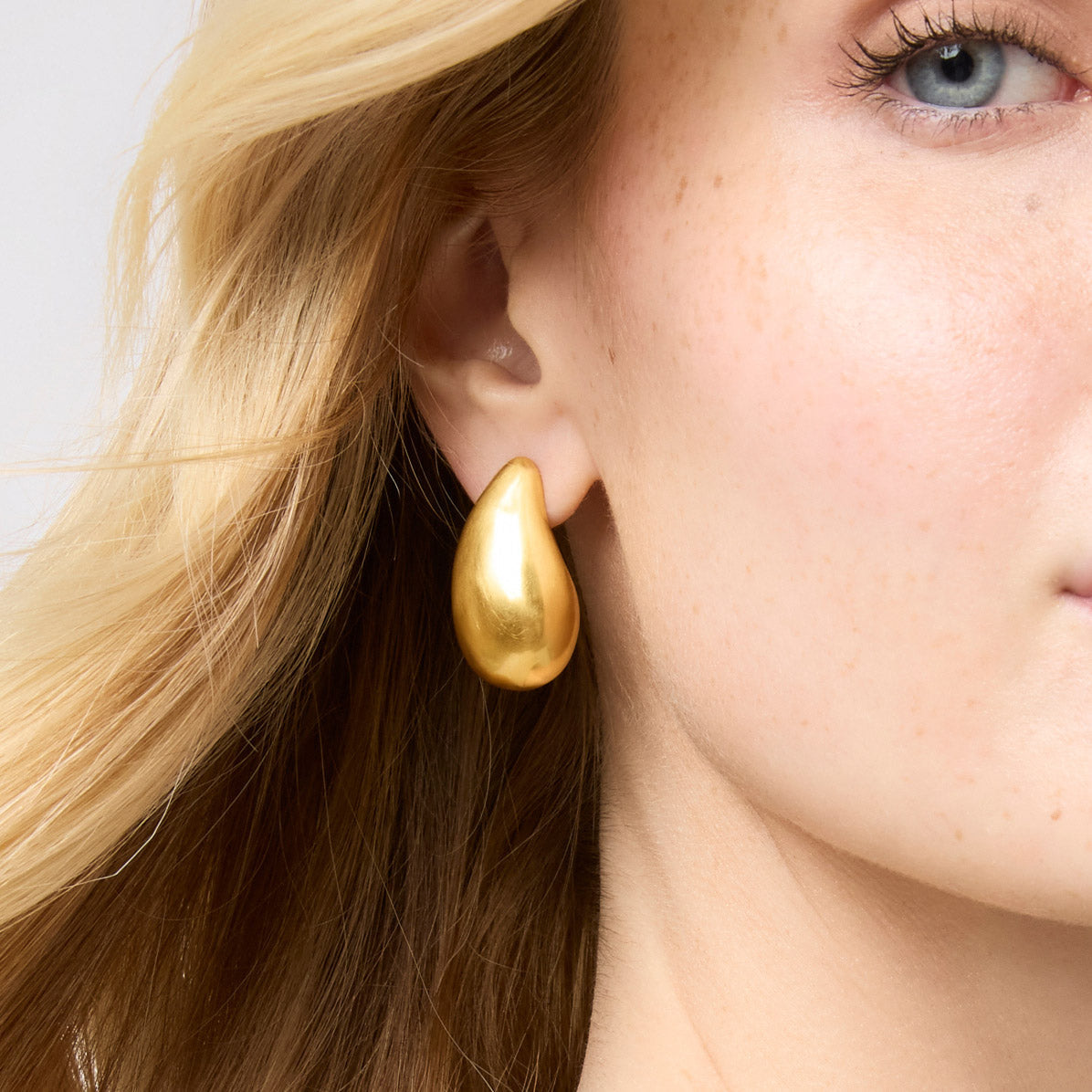 Three sizes of undulating Wave earrings in liquid gold with Julie Vos hallmark.