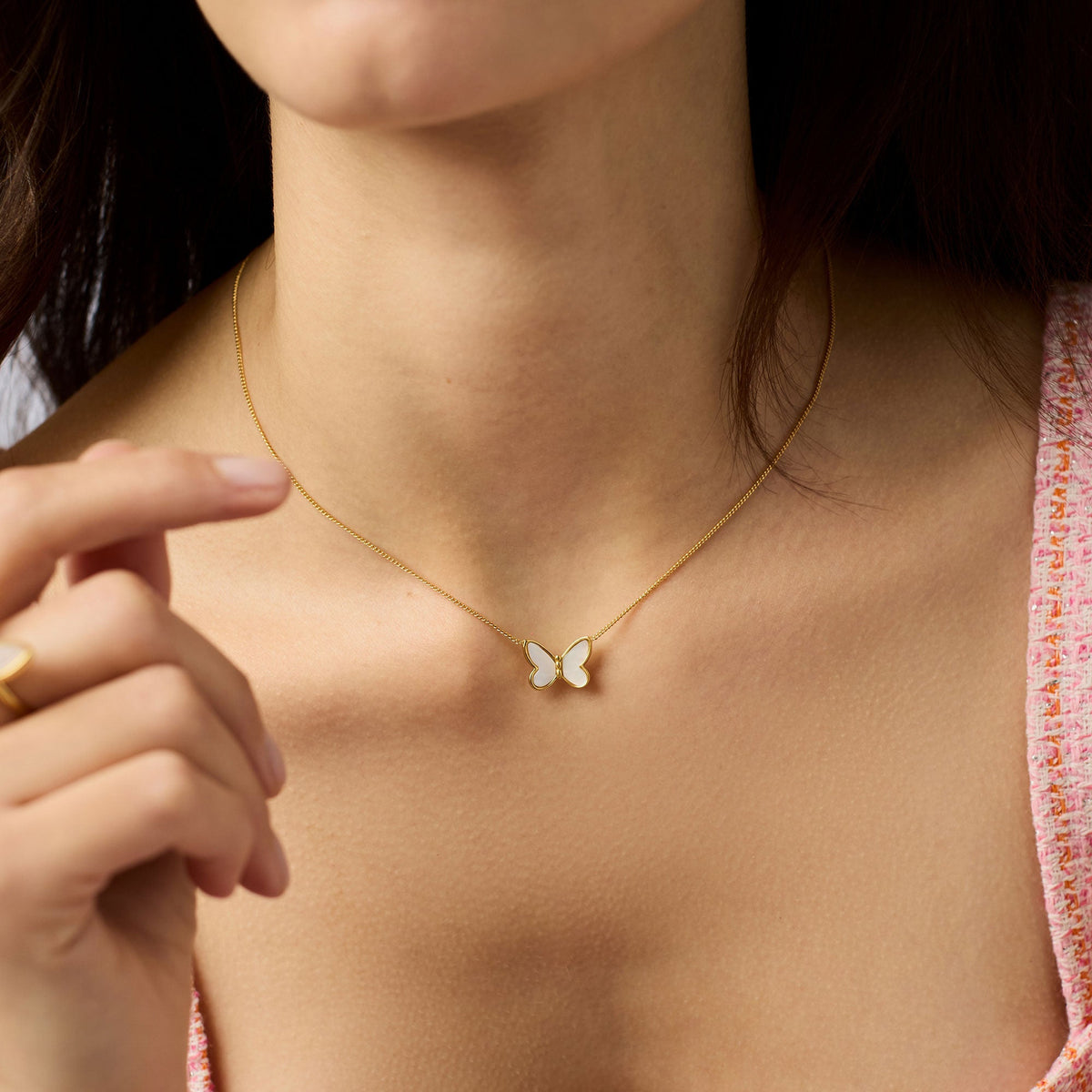 Adjustable Papillon necklace with mother-of-pearl pendant on a delicate gold plate chain.