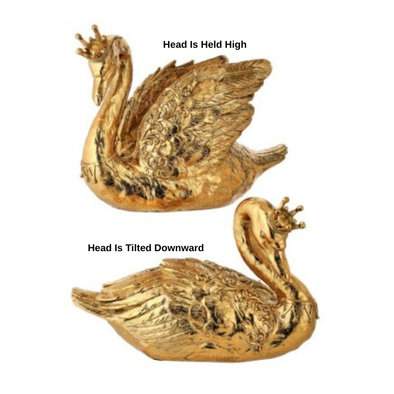 Two gold resin swan figurines with crowns, one with head held high and one with head tilted down.