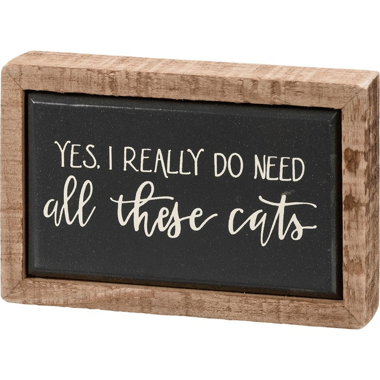 Wooden framed black sign with white text: "YES. I REALLY DO NEED all these cats"