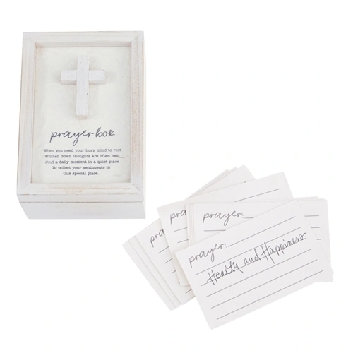 White wooden prayer box with a cross on top and a stack of lined prayer cards.