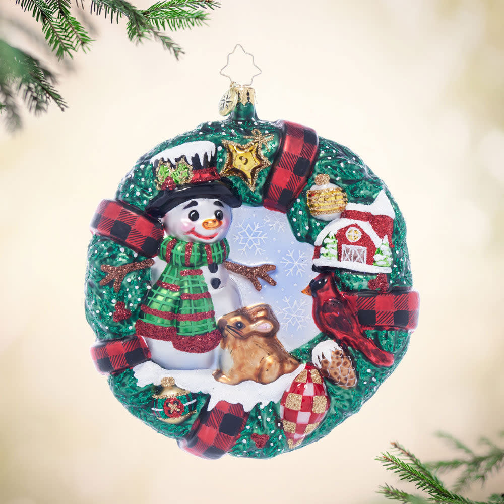 Rustic wreath ornament featuring two friendly figures in warm tones with a natural wood texture.